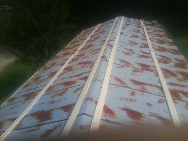 Rusted metal roof panels with new wood purlins before replacement — Storm Damage Roof Repair in Marathon by Roofing Brothers