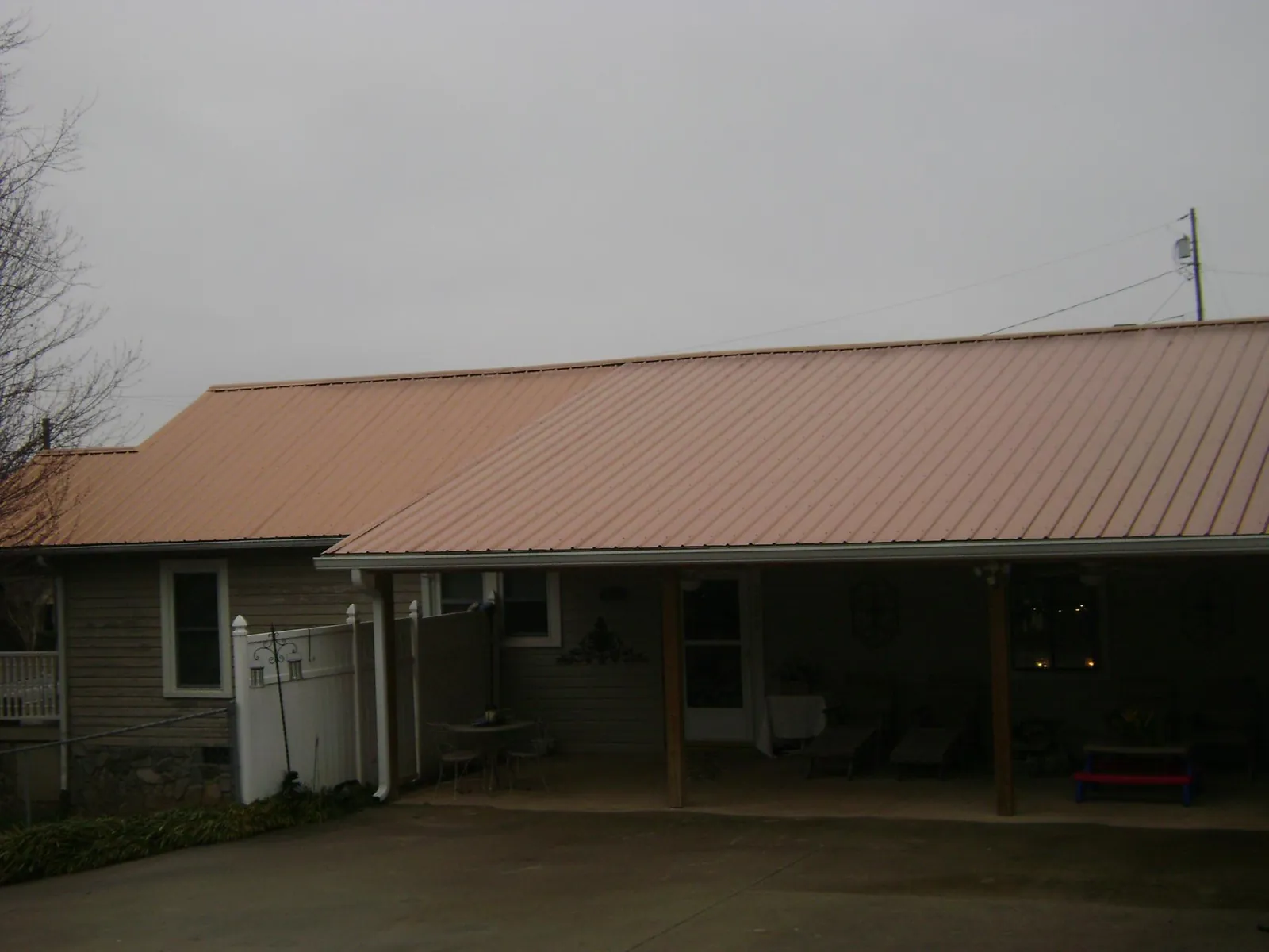 Copper toned metal roof over a wide covered patio in Marathon